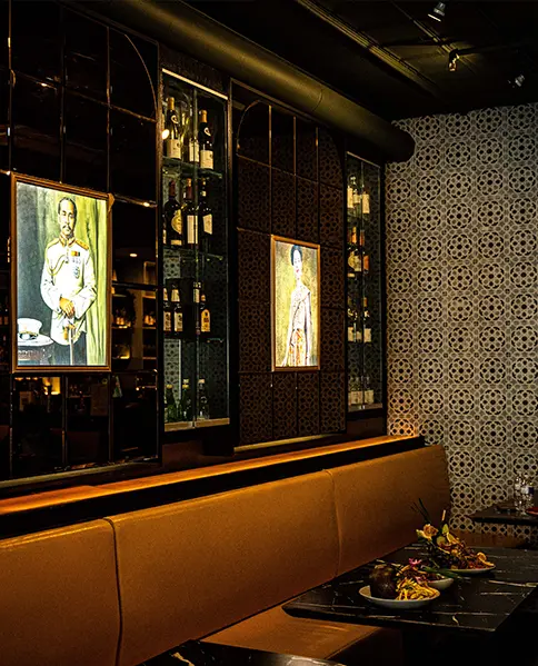 Restaurant interior with food on table, view of wine wall and photographs