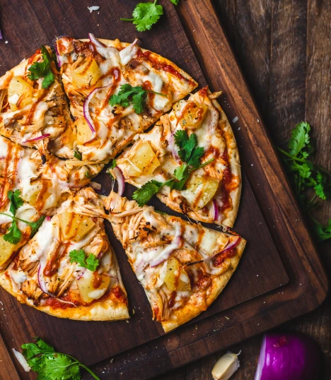 Sliced pizza on a wooden cutting board